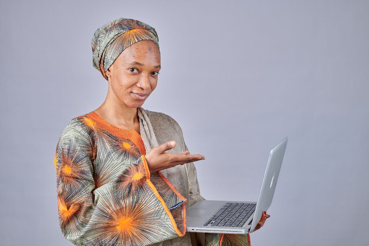Woman pointing at laptop showing the process